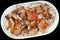 Plateful Of Gourmet Delicious Freshly Spit Roasted Tender Pork Shoulder Slices Isolated On Black Background