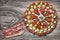 Plateful of Serbian Traditional Savory Appetizer Meze with Three Bacon Rashers Alongside Placed on Old Wood Background