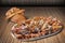 Plateful of Spit Roasted Pork Slices and Croissant Sesame Puff Pastry Set on Bamboo Place Mat Surface