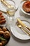 Plates with baked vegetables, golden forks