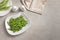 Plates with fresh green beans on table