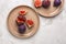 Plates with fresh ripe figs on light table