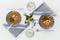 Plates and glasses, romantic dinner for two. Orange soup