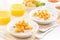 Plates of oatmeal with fresh apricots, orange juice and tea