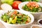 Plates of traditional Arabic salad fattouch and tabbouleh on a rustic background