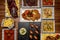 Plates and trays of typical recipes of Spanish gastronomy with croquette tapas, meatballs, beans with clams, garlic chicken, wine