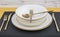 Plates and utensils, Plate, Bowl and golden cutlery on dining table, side view. Modern craft ceramic tableware, cutlery on the