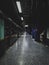 Platform edge doors and signs at a dark underground station in the evening