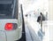 Platform and train, woman with rucksack, reflected in floor