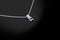Platinum precious chain with pendant diamonds sapphire on black background.