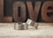 Platinum wedding rings in front of word Love