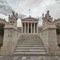 Plato and Socrates statues in front of the national academy of Athens Greece under impressive cloudy sky