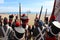 Platoon of napoleonic soldiers in formation with weapons and a flag, seen from behind