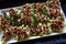 A platter of appetizing hors d oeuvres with colorful skewers on a black background