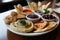 platter of assorted vegan delights: hummus, baba ghanoush, dolmeh and pita