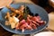 Platter with different meat and cheese products. Mediterranean appetizers, tapas or antipasto. Assorted Italian style banquet food