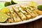 platter of grilled tofu and zesty lime wedges