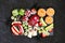 Platter of healthy Halloween fruit snacks, top view over a black stone background.