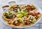 Platter of mexican street tacos with carne asada, chorizo, and al pastor in corn tortillas