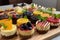 platter of mini cheesecakes in various flavors and colors