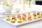 platter of mini eggs benedicts as appetizers for a party setting