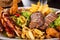 Platter of mixed meats, salad and French fries