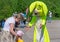 Play assistant in a suit of a green hare. Green rabbit holds out his hands to the child. Animator hare entertains children in the