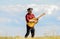 Play beautiful melody. Country music concept. Guitarist country singer stand in field sky background. Inspired country