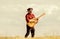 Play beautiful melody. Country music concept. Guitarist country singer stand in field sky background. Inspired country