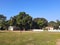 A PLAY GROUND, HUGE MANGO TREES,SUNNY DAY,BLUE SKY