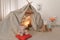 Play tent decorated with festive lights in modern child`s room