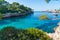 Playa de Cala Serena beach view on a sunny day, green vegetation around