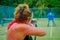 PLAYA DEL CARMEN, MEXICO - NOVEMBER, 09, 2017: Unidentified woman holding in her hands a rifle and shooting inside of a