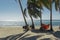 Playa giron, Cuba â€“ January 2, 2017: Travelers relaxing on hammocks with bikes on tropical beach in Cuba, travel concept
