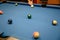 Player aiming green ball billiard on billiard pool