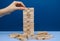 Player hand build Jenga tower constructed