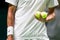 Player holding tennis balls before serving