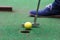 Player makes a decisive blow in the game of mini golf