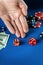 The player places a bet in a dice game or craps on a blue table in a poker club. Luck or fortune in the casino