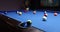 Player throwing colored balls on billiard pool table