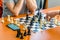 Players play chess on a chessboard with chess pieces in a tournament