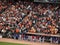 Players stand with hats removed in front of dugout