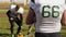 Players watching coin toss before American football match, beginning of game