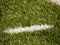 Playfield border. Closeup view to white lines on football playground. Detail of a of white lines