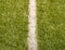 Playfield border. Closeup view to white lines on football playground. Detail of a of white lines