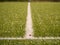 Playfield border. Closeup view to white lines on football playground. Detail of a of white lines