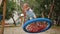 Playful active kid swinging on round rope swing on playground, having fun