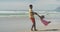 Playful african american father spinning his daughter on the beach