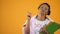 Playful african american student having fun holding pencil with lips, college