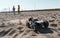 Playful baby kids driving radio controlled off road high speed sport buggy car on sand black SUV rc